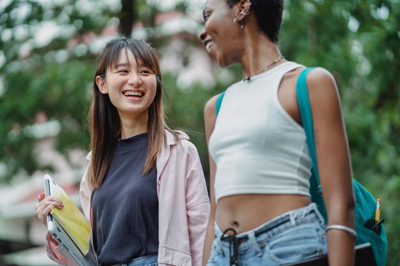 Two students talking as they walk together